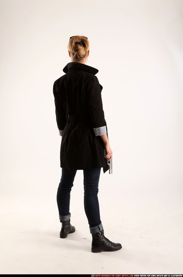 Woman Adult Athletic White Fighting with gun Standing poses Coat