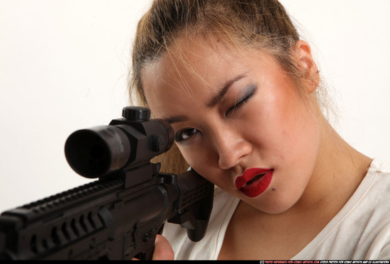 Woman Young Average Fighting with submachine gun Sitting poses Casual Asian