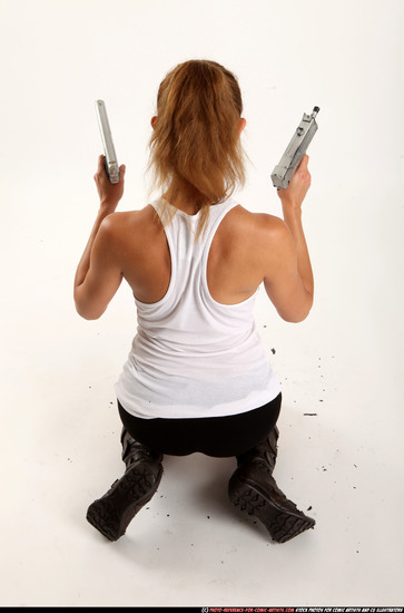 Woman Adult Athletic White Fighting with gun Kneeling poses Casual