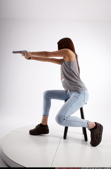 Woman Adult Athletic White Fighting with gun Sitting poses Casual