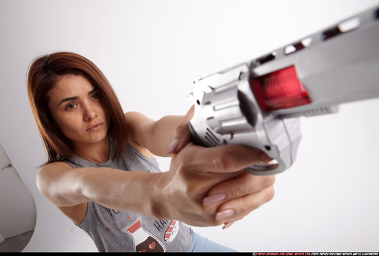 Woman Adult Athletic White Fighting with gun Sitting poses Casual