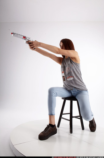 Woman Adult Athletic White Fighting with gun Sitting poses Casual