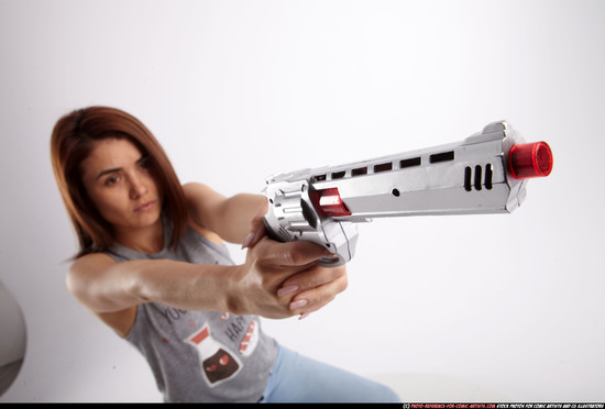 Woman Adult Athletic White Fighting with gun Sitting poses Casual