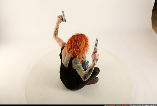 Woman Adult Athletic White Fighting with gun Sitting poses Casual