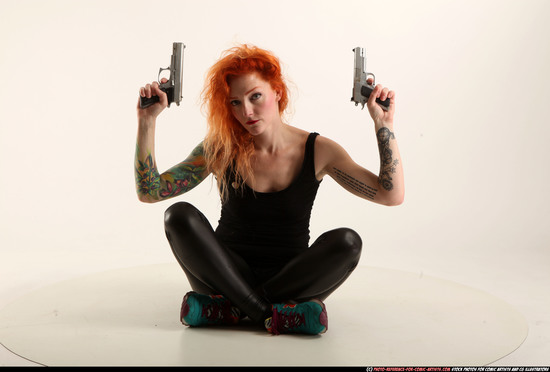 Woman Adult Athletic White Fighting with gun Sitting poses Casual