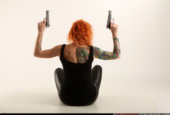 Woman Adult Athletic White Fighting with gun Sitting poses Casual