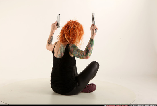 Woman Adult Athletic White Fighting with gun Sitting poses Casual