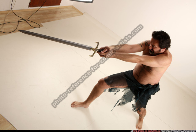Free Photo | Male model in gladiator pose with sword and shield isolated on  a grey background.