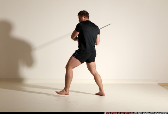 Man Adult Muscular White Fighting with sword Kneeling poses Sportswear