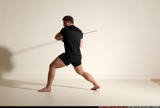 Man Adult Muscular White Fighting with sword Kneeling poses Sportswear