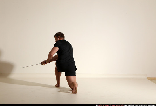 Man Adult Muscular White Fighting with sword Kneeling poses Sportswear