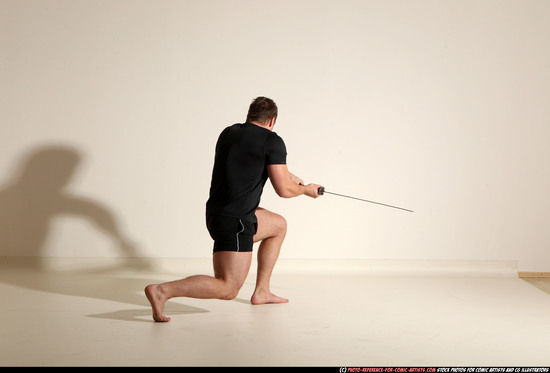 Man Adult Muscular White Fighting with sword Kneeling poses Sportswear