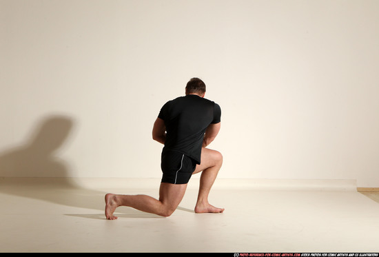 Man Adult Muscular White Fighting with sword Kneeling poses Sportswear