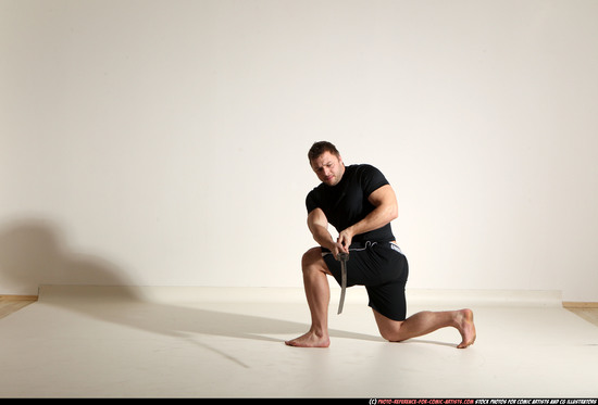 Man Adult Muscular White Fighting with sword Kneeling poses Sportswear