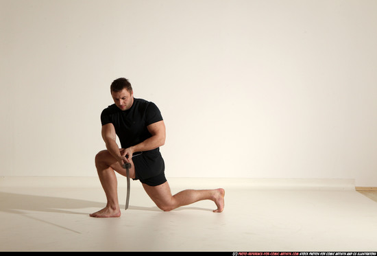 Man Adult Muscular White Fighting with sword Kneeling poses Sportswear