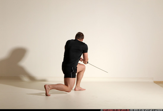 Man Adult Muscular White Fighting with sword Kneeling poses Sportswear