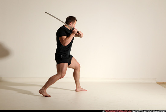 Man Adult Muscular White Fighting with sword Kneeling poses Sportswear