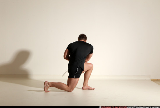 Man Adult Muscular White Fighting with sword Kneeling poses Sportswear