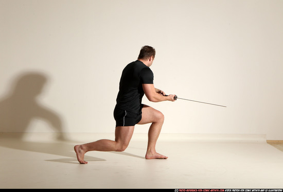 Man Adult Muscular White Fighting with sword Kneeling poses Sportswear