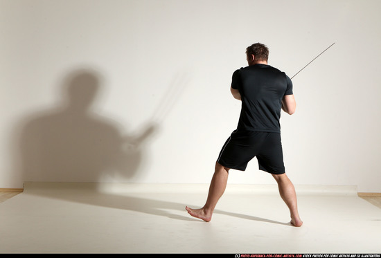 Man Adult Muscular White Fighting with sword Kneeling poses Sportswear