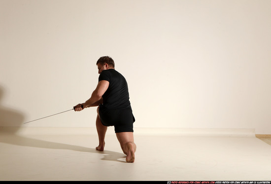 Man Adult Muscular White Fighting with sword Kneeling poses Sportswear