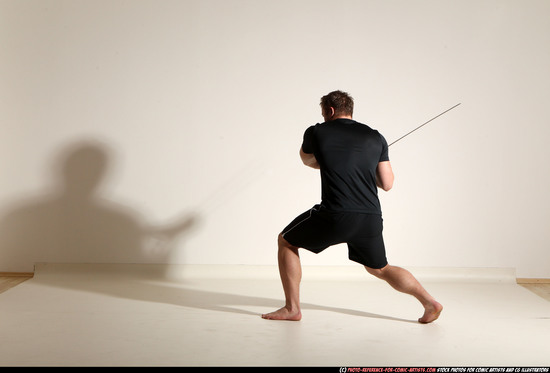 Man Adult Muscular White Fighting with sword Kneeling poses Sportswear