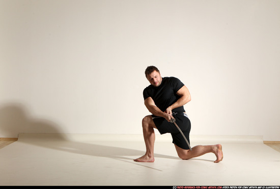 Man Adult Muscular White Fighting with sword Kneeling poses Sportswear