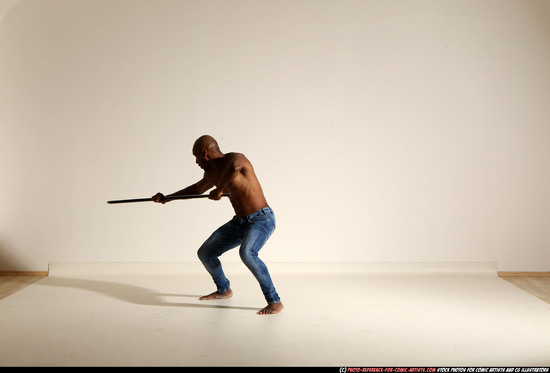 Man Adult Athletic Black Fighting with spear Moving poses Pants