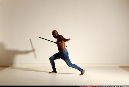 Man Adult Athletic Black Fighting with spear Moving poses Pants