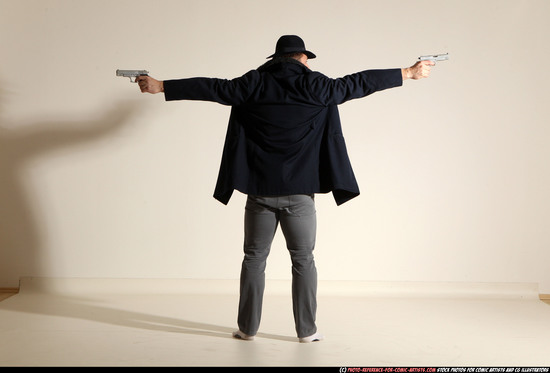 Man Adult Muscular White Fighting with gun Standing poses Coat