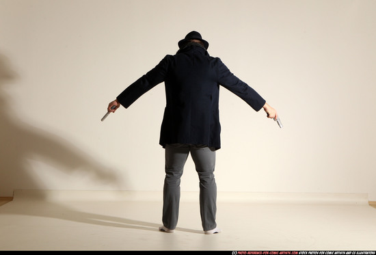 Man Adult Muscular White Fighting with gun Standing poses Coat