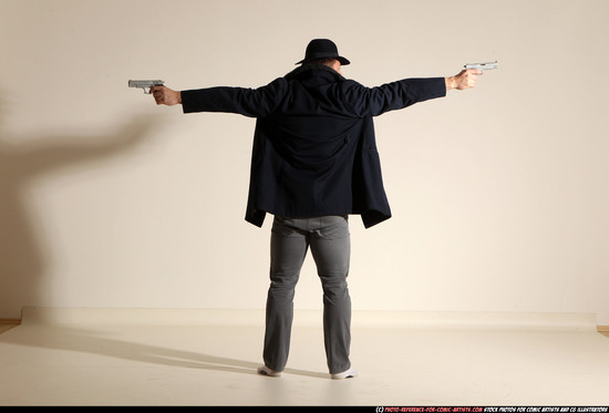 Man Adult Muscular White Fighting with gun Standing poses Coat