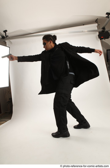 Man Adult Average Black Fighting with gun Standing poses Coat