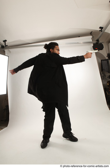 Man Adult Average Black Fighting with gun Standing poses Coat