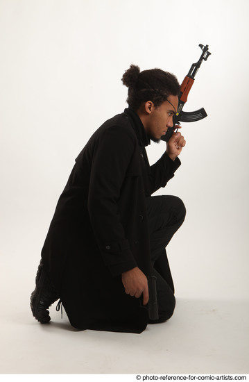 Man Adult Average Black Fighting with gun Sitting poses Coat