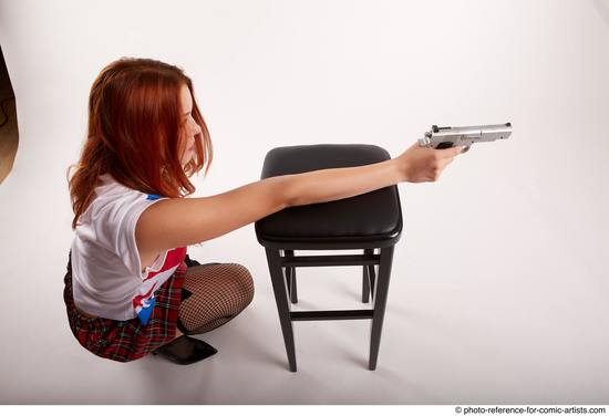 Woman Adult Average White Fighting with gun Kneeling poses Casual