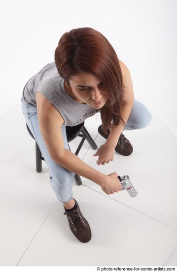 Woman Adult Athletic White Fighting with gun Sitting poses Casual