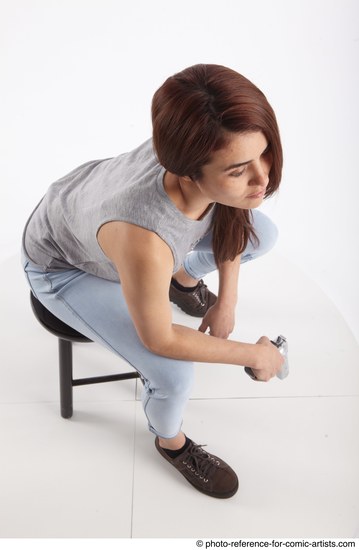 Woman Adult Athletic White Fighting with gun Sitting poses Casual