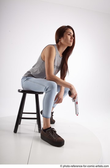 Woman Adult Athletic White Fighting with gun Sitting poses Casual