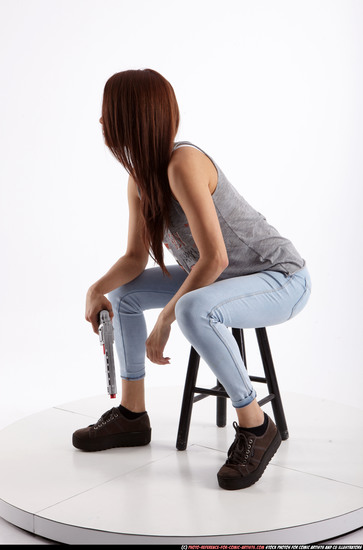 Woman Adult Athletic White Fighting with gun Sitting poses Casual