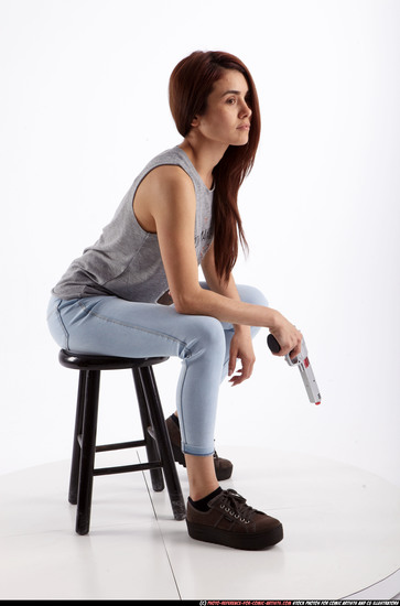 Woman Adult Athletic White Fighting with gun Sitting poses Casual