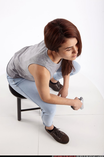 Woman Adult Athletic White Fighting with gun Sitting poses Casual