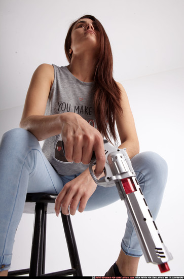 Woman Adult Athletic White Fighting with gun Sitting poses Casual