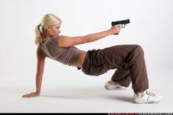 Woman Young Athletic White Fighting with gun Kneeling poses Sportswear