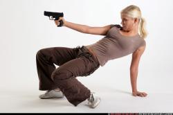 Woman Young Athletic White Fighting with gun Kneeling poses Sportswear
