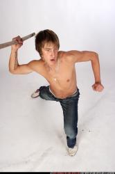 Man Young Muscular White Fighting with spear Kneeling poses Pants