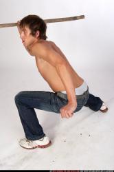 Man Young Muscular White Fighting with spear Kneeling poses Pants