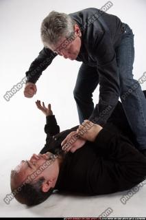 men-fist-fighting-on-ground