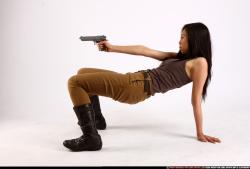 Woman Young Athletic Fighting with gun Laying poses Asian