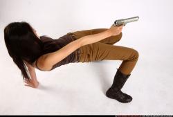 Woman Young Athletic Fighting with gun Laying poses Asian